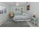 Cozy bedroom with carpet, a comfortable bed, and natural light streaming through the windows at 601 Apalachicola Rd, Venice, FL 34285