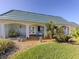 Charming home featuring a light blue tile roof and a well-manicured lawn at 601 Apalachicola Rd, Venice, FL 34285