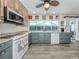 Bright kitchen features blue cabinetry, a large window over the sink, and stainless steel appliances at 601 Apalachicola Rd, Venice, FL 34285