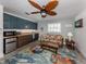 Living room featuring a wet bar with upper and lower cabinets with sofa, ceiling fan and area rug at 601 Apalachicola Rd, Venice, FL 34285