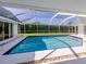 Clean and modern screened-in pool with clear blue water and well-maintained patio at 601 Apalachicola Rd, Venice, FL 34285