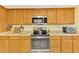 Well-lit kitchen featuring custom wood cabinets and stainless steel appliances at 6146 Rockefeller Ave, Sarasota, FL 34231