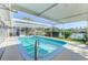 Beautiful, screened-in pool featuring an outdoor patio space and lake view at 6146 Rockefeller Ave, Sarasota, FL 34231