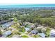 Expansive aerial view of a peaceful residential area with lush trees, waterfront views, and neatly arranged homes at 6216 Pecan Rd, Venice, FL 34293