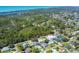 Scenic aerial view of a residential neighborhood near a waterway featuring lush greenery and beautiful blue water views at 6216 Pecan Rd, Venice, FL 34293