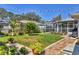 Well-maintained backyard with lawn, landscaping, and a screened-in porch at 6216 Pecan Rd, Venice, FL 34293