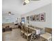 Inviting dining area with a rustic wooden table, modern decor, and a view into the living room at 6216 Pecan Rd, Venice, FL 34293