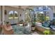 Inviting front porch featuring a decorative archway, tile flooring, and comfortable seating area with lush greenery at 6216 Pecan Rd, Venice, FL 34293