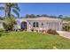 Charming single-story home with a well-manicured lawn, mature landscaping, and a welcoming front entrance at 6216 Pecan Rd, Venice, FL 34293