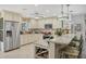 Well-appointed kitchen with stainless steel appliances, granite countertops, wine rack, and modern lighting fixtures at 6216 Pecan Rd, Venice, FL 34293