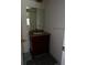 Bathroom featuring a single vanity with granite countertop and tiled floor at 649 S Tamiami S Trl # 304, Venice, FL 34285