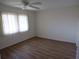 A bedroom featuring hardwood floors, a ceiling fan, and a large window at 649 S Tamiami S Trl # 304, Venice, FL 34285