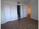 Bedroom with hardwood floors, a view into the bathroom, and an open doorway at 649 S Tamiami S Trl # 304, Venice, FL 34285