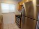 Kitchen with stainless steel appliances, granite countertops, tile floor, and a window at 649 S Tamiami S Trl # 304, Venice, FL 34285