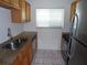 Kitchen featuring stainless steel appliances, double sink, granite counters, and wood cabinets at 649 S Tamiami S Trl # 304, Venice, FL 34285