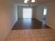 Living room with hardwood floors, sliding glass door, and neutral paint at 649 S Tamiami S Trl # 304, Venice, FL 34285