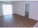 Bright living room with hardwood floors, large sliding glass door, and neutral paint at 649 S Tamiami S Trl # 304, Venice, FL 34285