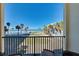 Charming balcony with stunning ocean views, palm trees, clear skies, and nearby resort at 700 Golden Beach Blvd # 224, Venice, FL 34285