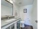 Bathroom with a modern vanity, sleek countertops, and a toilet, creating a clean, functional space at 700 Golden Beach Blvd # 224, Venice, FL 34285