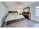 Bedroom with a dark wood bed frame and dresser complemented by a modern ceiling fan at 700 Golden Beach Blvd # 224, Venice, FL 34285