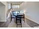 Bright and airy dining area featuring a table and chairs with a staircase leading to the upper level at 700 Golden Beach Blvd # 224, Venice, FL 34285