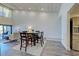 Open-concept dining area with modern decor, table, and chairs near the living room with access to a patio at 700 Golden Beach Blvd # 224, Venice, FL 34285