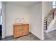 Home entryway with a charming wooden cabinet, decor, and a view of the staircase to the right at 700 Golden Beach Blvd # 224, Venice, FL 34285