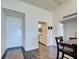 Open-concept condo entryway with dining area, kitchen view, and wood-look flooring at 700 Golden Beach Blvd # 224, Venice, FL 34285