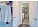 Hallway with closet and bathroom view, showcasing the home's layout and storage solutions at 700 Golden Beach Blvd # 224, Venice, FL 34285