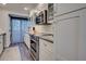 Bright kitchen with stainless steel appliances, sleek countertops, and cabinets, plus laundry area at 700 Golden Beach Blvd # 224, Venice, FL 34285
