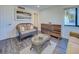 Living room with stylish decor, wicker seating, decorative storage unit, and a modern aesthetic at 700 Golden Beach Blvd # 224, Venice, FL 34285
