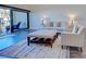 Cozy living room with comfortable seating, large windows to the outside balcony, and modern rug at 700 Golden Beach Blvd # 224, Venice, FL 34285