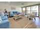 Inviting living room with comfortable seating and a sliding glass door leading to the outdoors at 700 Golden Beach Blvd # 224, Venice, FL 34285