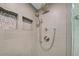 Luxurious shower featuring sleek gray tile, dual shower heads, and pebble stone niches at 700 Golden Beach Blvd # 224, Venice, FL 34285