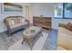 Sitting room with wicker chairs, glass coffee table, modern dresser, and artwork at 700 Golden Beach Blvd # 224, Venice, FL 34285