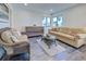 Inviting sitting room featuring wicker furniture, accent pillows, modern chest, and beach view at 700 Golden Beach Blvd # 224, Venice, FL 34285