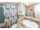 Bathroom with floral shower curtain and a vanity with a solid surface countertop at 72 Circlewood Dr # A2-7, Venice, FL 34293