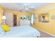 Bedroom featuring bright yellow walls and a comfortable queen bed with closet access at 72 Circlewood Dr # A2-7, Venice, FL 34293