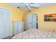 Cozy bedroom with carpeting, closet and a sunny, bright yellow color palette at 72 Circlewood Dr # A2-7, Venice, FL 34293