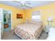 Cozy bedroom with carpet, ceiling fan and a bright, sunny, yellow color palette at 72 Circlewood Dr # A2-7, Venice, FL 34293