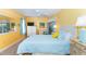 Bright bedroom featuring a queen bed, ceiling fan, and matching dresser and nightstands at 72 Circlewood Dr # A2-7, Venice, FL 34293