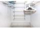 White walk in closet with multiple metal shelves perfect for organization at 72 Circlewood Dr # A2-7, Venice, FL 34293