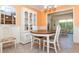 Bright dining area featuring tile floors, built-in storage, and view of lanai at 72 Circlewood Dr # A2-7, Venice, FL 34293