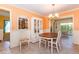 Charming dining area featuring neutral colors, built-in china cabinet, and tiled flooring at 72 Circlewood Dr # A2-7, Venice, FL 34293