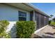 Side view of the home showing the screened-in porch area and clean landscaping at 72 Circlewood Dr # A2-7, Venice, FL 34293