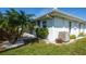Exterior view of a well-maintained home with lush landscaping and a clean, white facade at 72 Circlewood Dr # A2-7, Venice, FL 34293