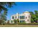 Elegant two-story home with turret, arched windows, lush landscaping, and mature trees for a picturesque setting at 72 Circlewood Dr # A2-7, Venice, FL 34293