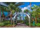 Entrance to Venice Fishing Pier, lined with palm trees, lush landscaping and turquoise waters at 72 Circlewood Dr # A2-7, Venice, FL 34293