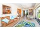 Living room featuring a couch, tile floors, and a sliding door leading to the backyard at 72 Circlewood Dr # A2-7, Venice, FL 34293