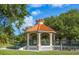 Picturesque gazebo featuring a tiled roof and sturdy columns, nestled in a scenic green space with mature trees at 72 Circlewood Dr # A2-7, Venice, FL 34293